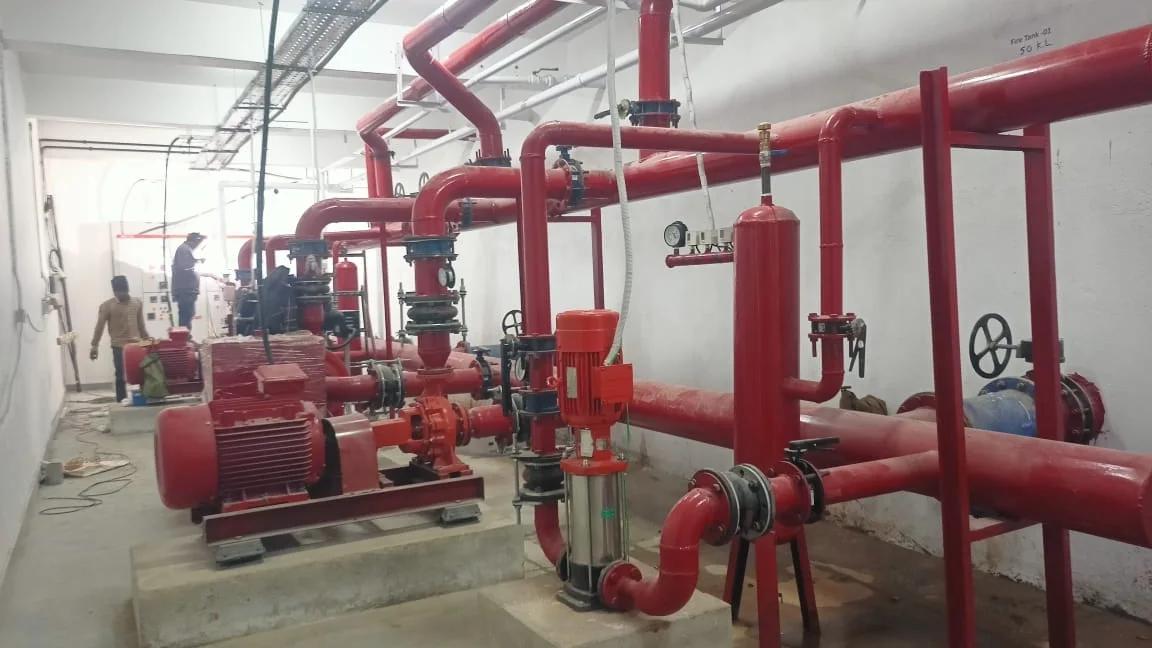 Fire pump room with red hydrant piping and pumps